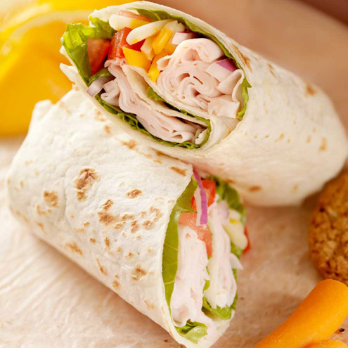 Fresh tortilla wraps with chicken and fresh vegetables on plate
